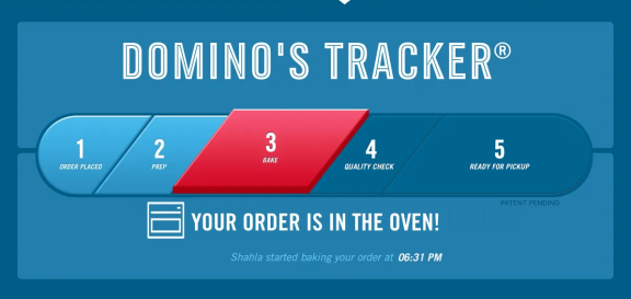 Domino’s Tracker progress bar showing step 3, “Bake,” highlighted in red. The text reads: “Your order is in the oven! Shahla started baking your order at 06:31 PM.” Steps 1, 2, 4, and 5 are also shown.