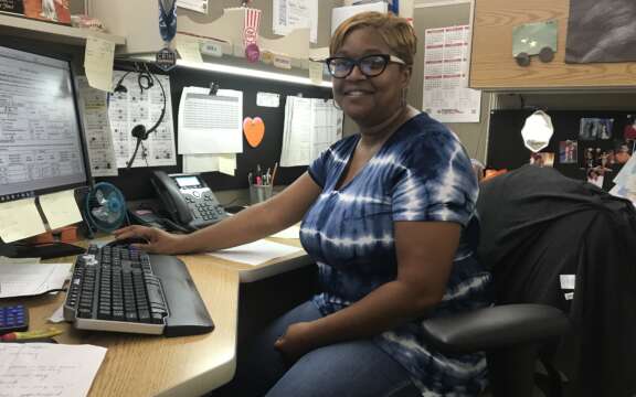 A woman sitting at a desk with a computer.