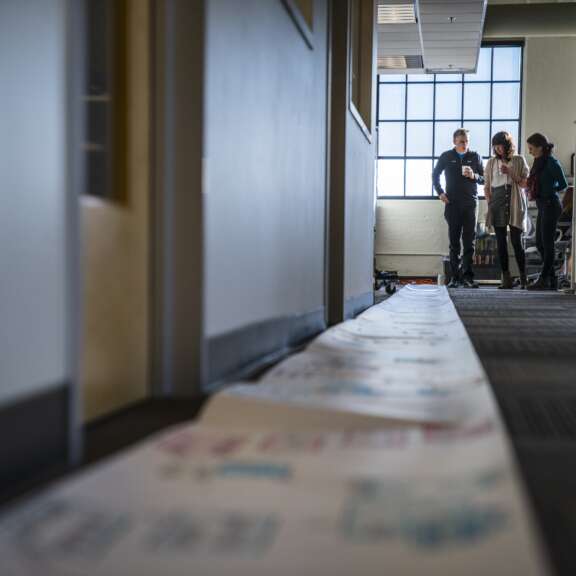 A group of people standing in a hallway.